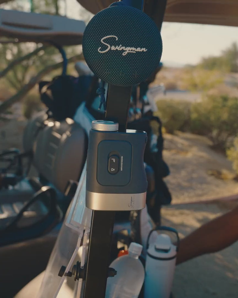 Golfers in a cart with the Swingman Magnetic Speaker mounted